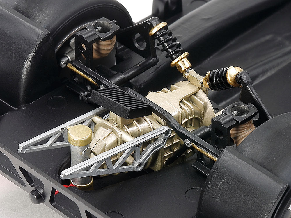 The underside features depictions of the transmission case and the diagonally-fixed rear suspension dampers.