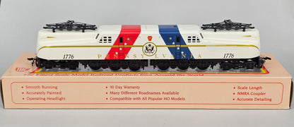 International Hobby Corp HO Scale M9666 GG-1 Premier PRR Spirit of '76 White with Red & Blue diagonal bands (DC Only) with working pantpgraph and directional lighting. - Chester Model Centre