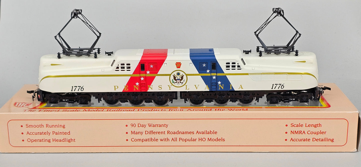 International Hobby Corp HO Scale M9666 GG-1 Premier PRR Spirit of '76 White with Red & Blue diagonal bands (DC Only) with working pantpgraph and directional lighting. - Chester Model Centre